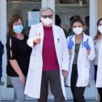 Group pic of medical providers in masks with thumbs up